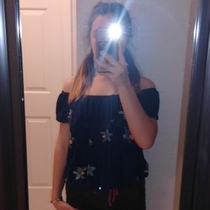 I am selling a off the shoulder navy blue shirt .